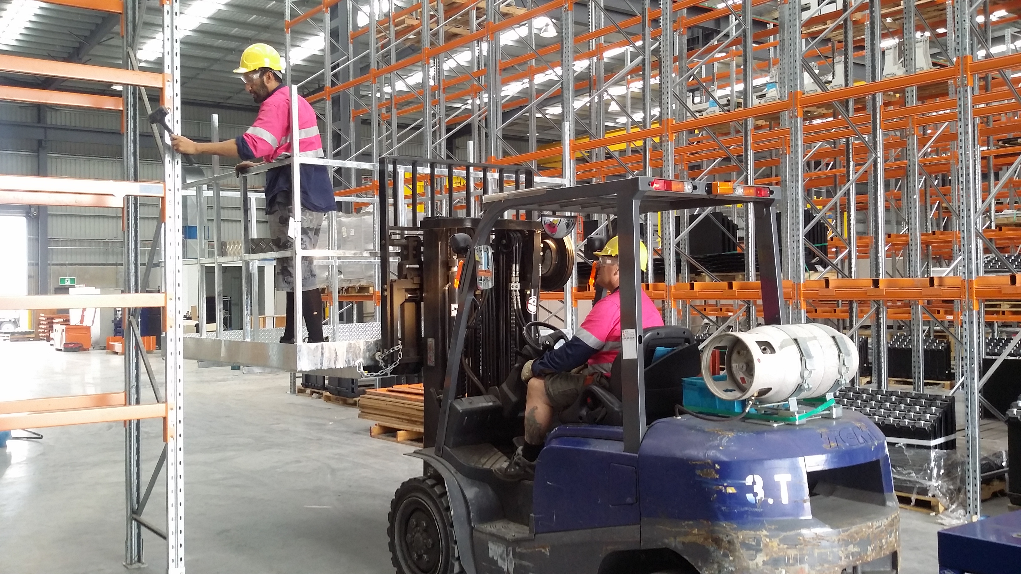 Two employees building pallet racking