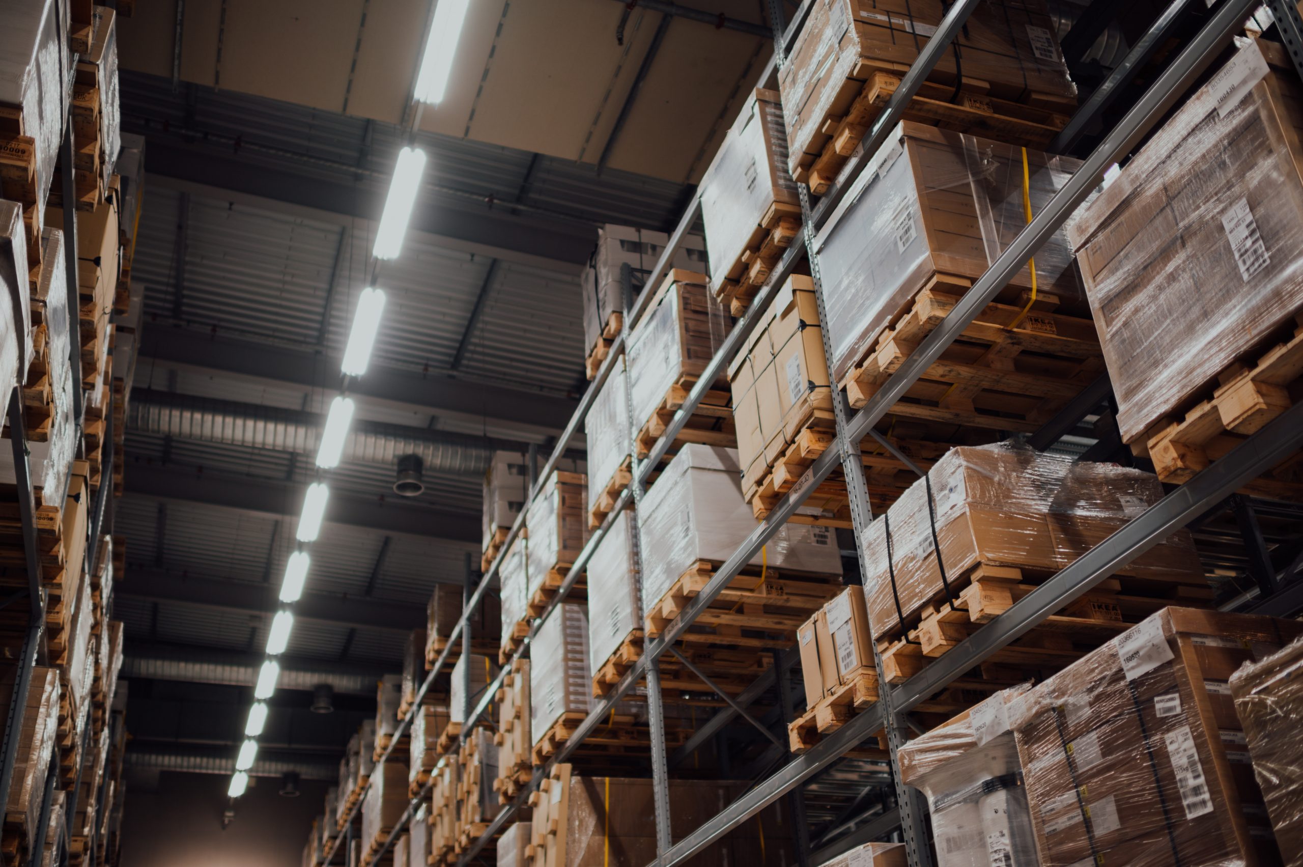 warehouse shelves stacked with pallets of supplies