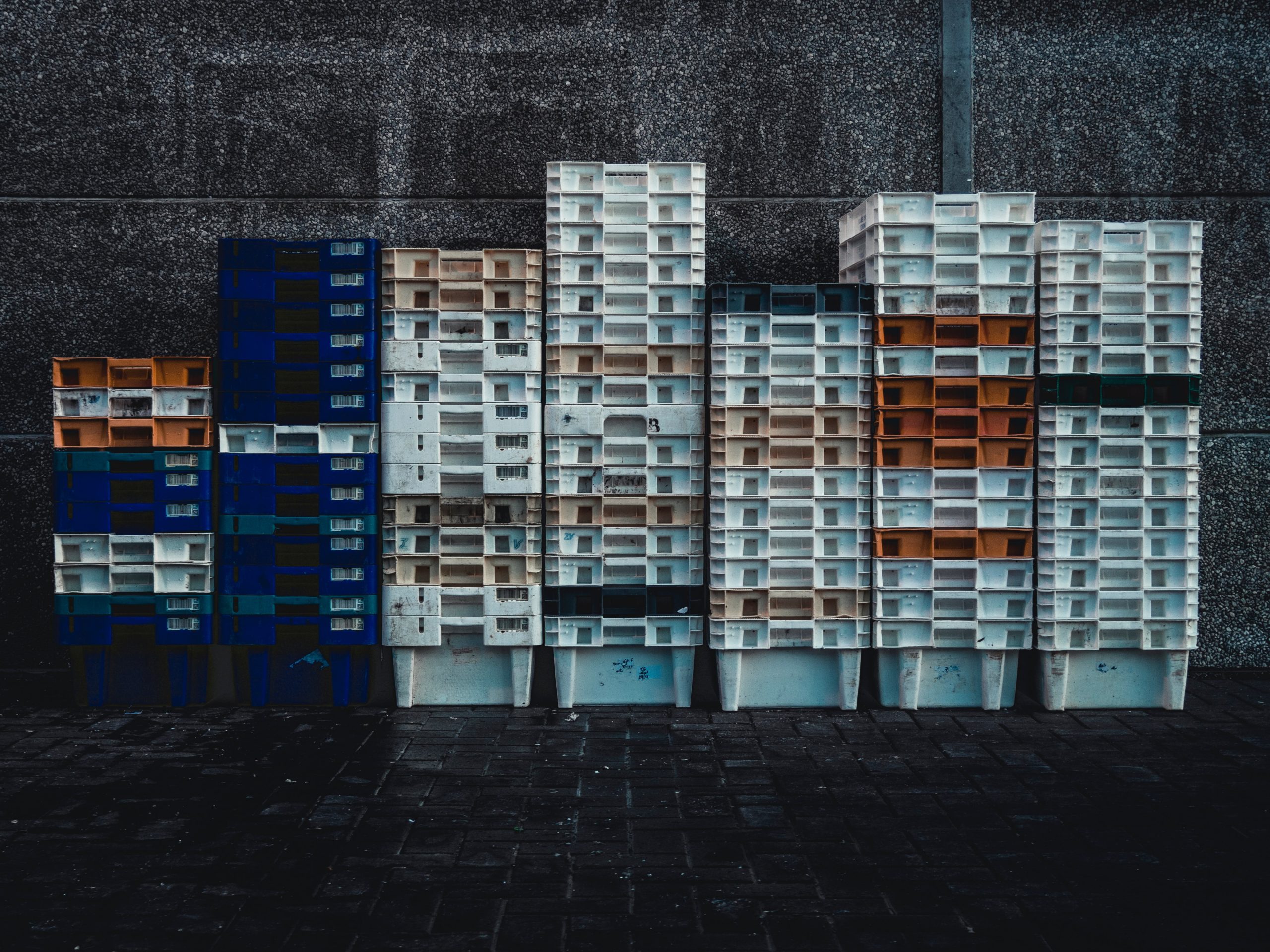 plastic storage containers stacked up against wall