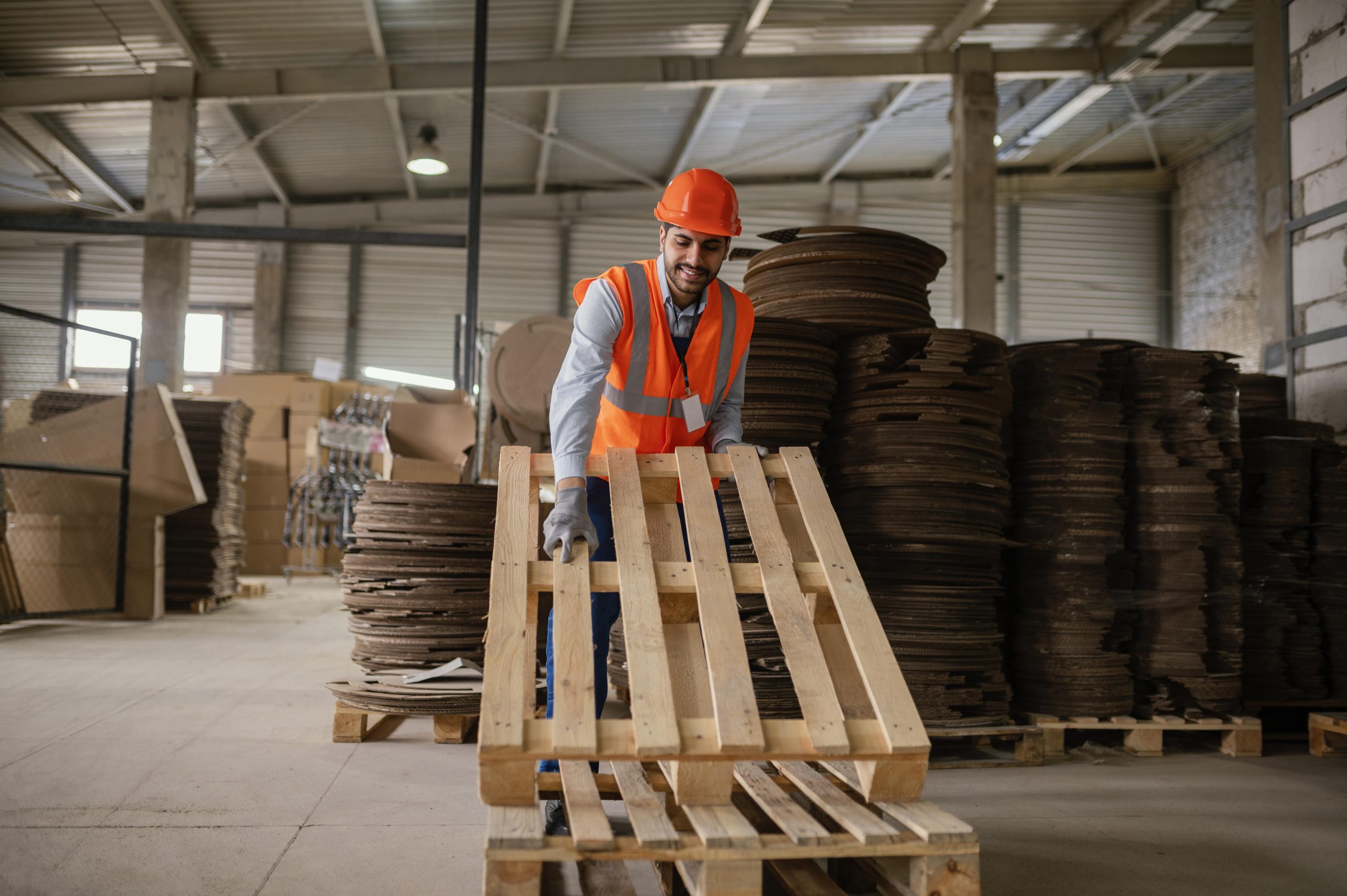 Man working with heavy wooden material
