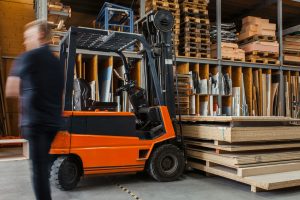 black and orange forklift with large boxes on it